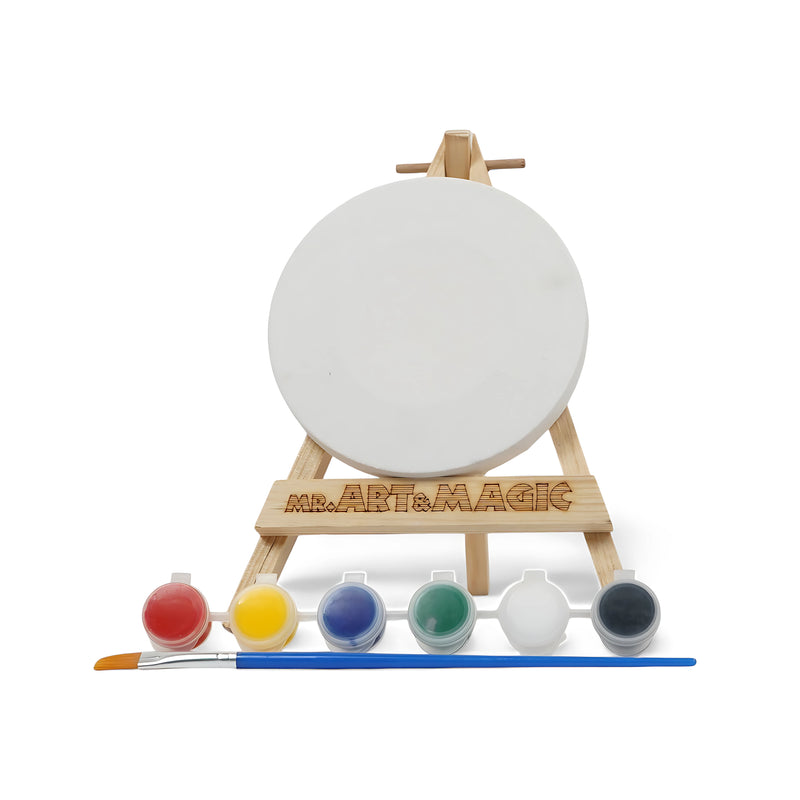 Art & Magic Mini Round Canvas Painting Set with mini round canvas, wooden easel, six paint colors, and a paintbrush for compact art projects.

