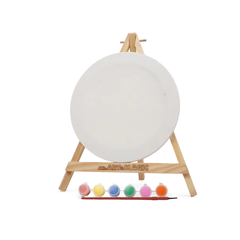 Art & Magic Round Canvas Painting Set with pastel colors, including a round canvas, wooden easel, six pastel paints, and a paintbrush for gentle-hued art projects.

