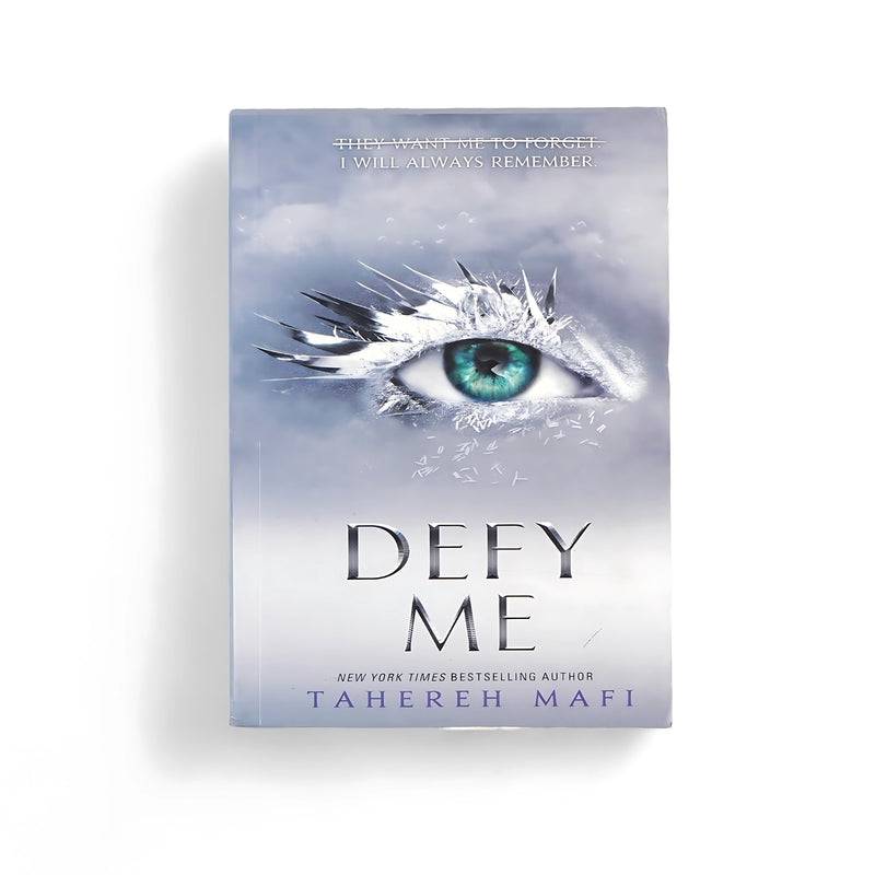 Cover of Defy Me by Tahereh Mafi, featuring an icy blue eye with shattered fragments, symbolizing memory and conflict.


