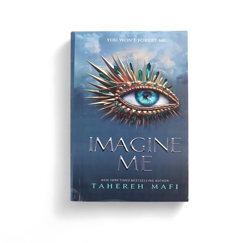 Cover of Imagine Me by Tahereh Mafi, featuring a striking blue eye surrounded by jewel-like spikes, symbolizing power and transformation, against a dark sky background.

