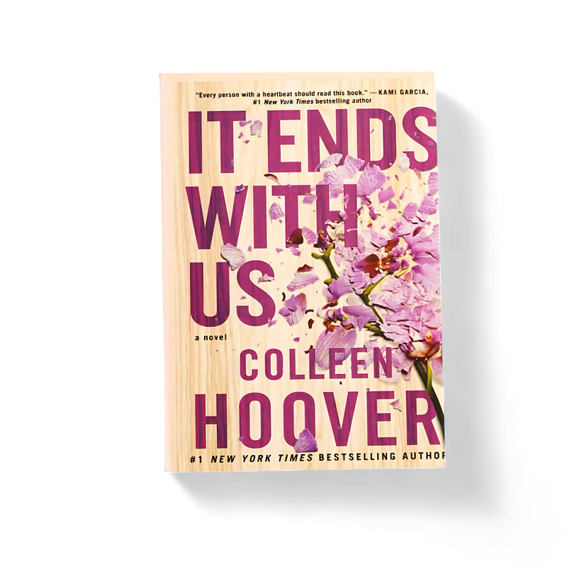 Cover of It Ends With Us by Colleen Hoover, featuring shattering purple flowers on a wood-like background, symbolizing the fragility and strength portrayed in the novel's emotional narrative.






