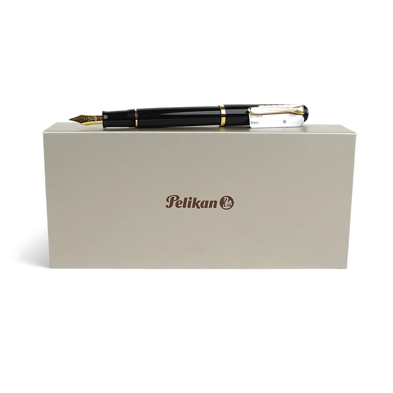 Pelikan Souverän M800 Fountain Pen in black with gold-plated trim, displayed with its gift box, offering a luxurious writing experience for professionals and enthusiasts.

