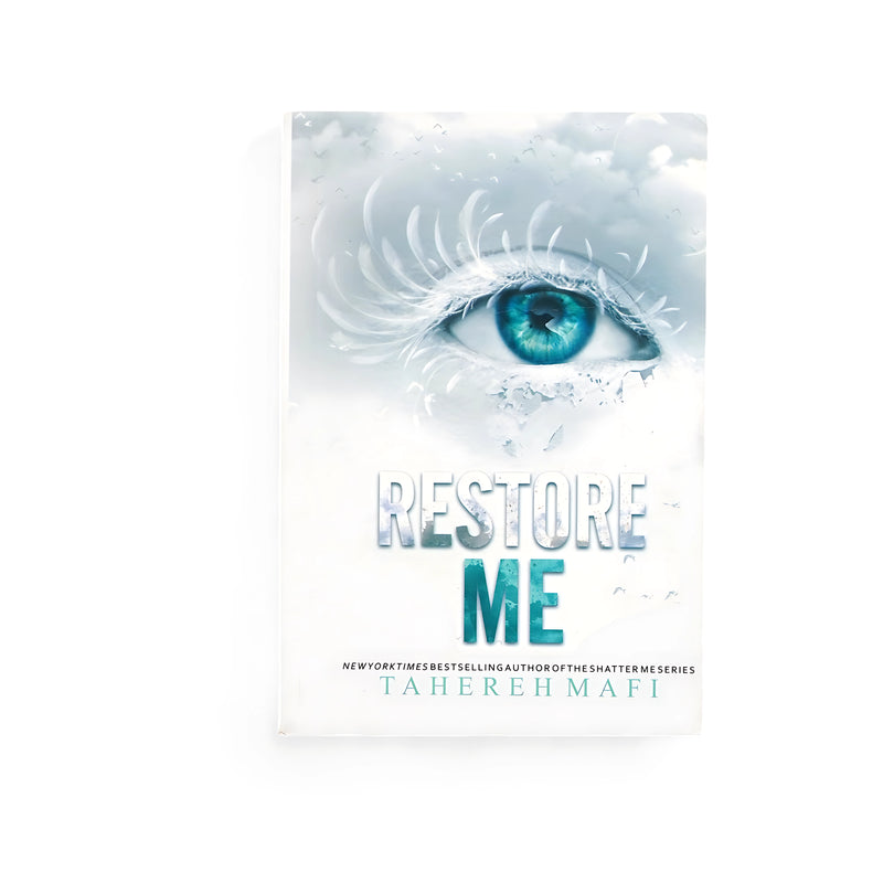 Cover of Restore Me by Tahereh Mafi, featuring a vivid blue eye surrounded by delicate frost and cracks, symbolizing fragility and transformation.

