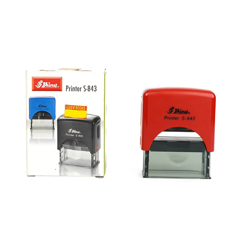 Shiny Printer S-843 self-inking stamp with red housing, packaged with product instructions and Azeem Books price label.

