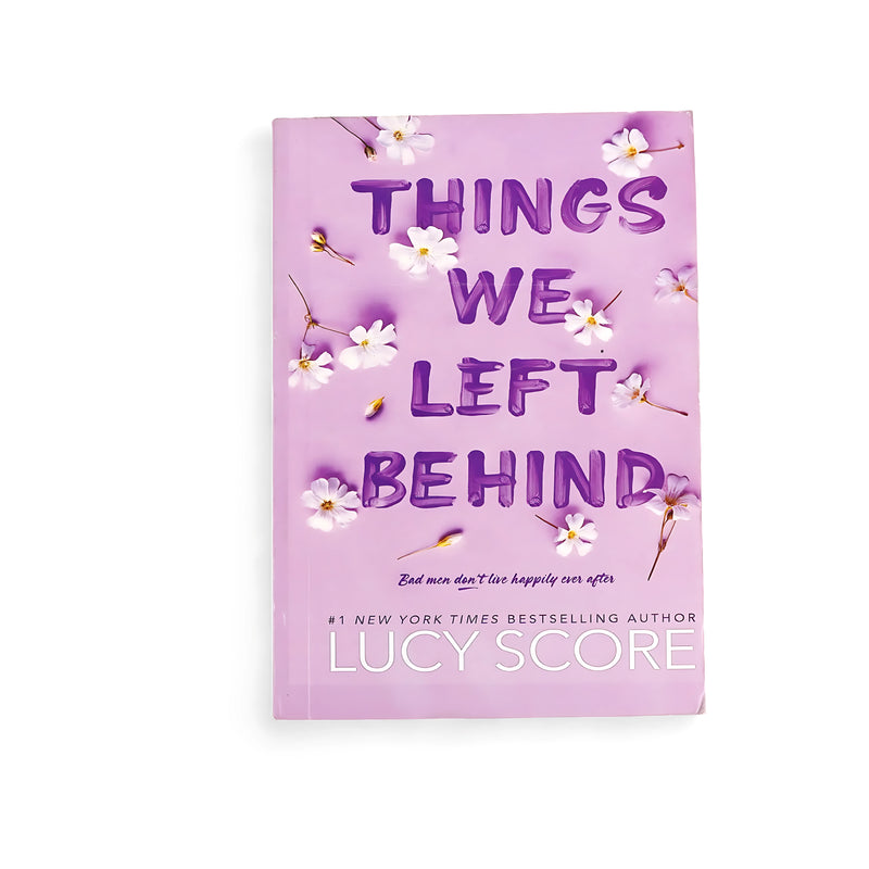 Cover of Things We Left Behind by Lucy Score featuring a lilac background with white flowers, symbolizing love, forgiveness, and transformation.






